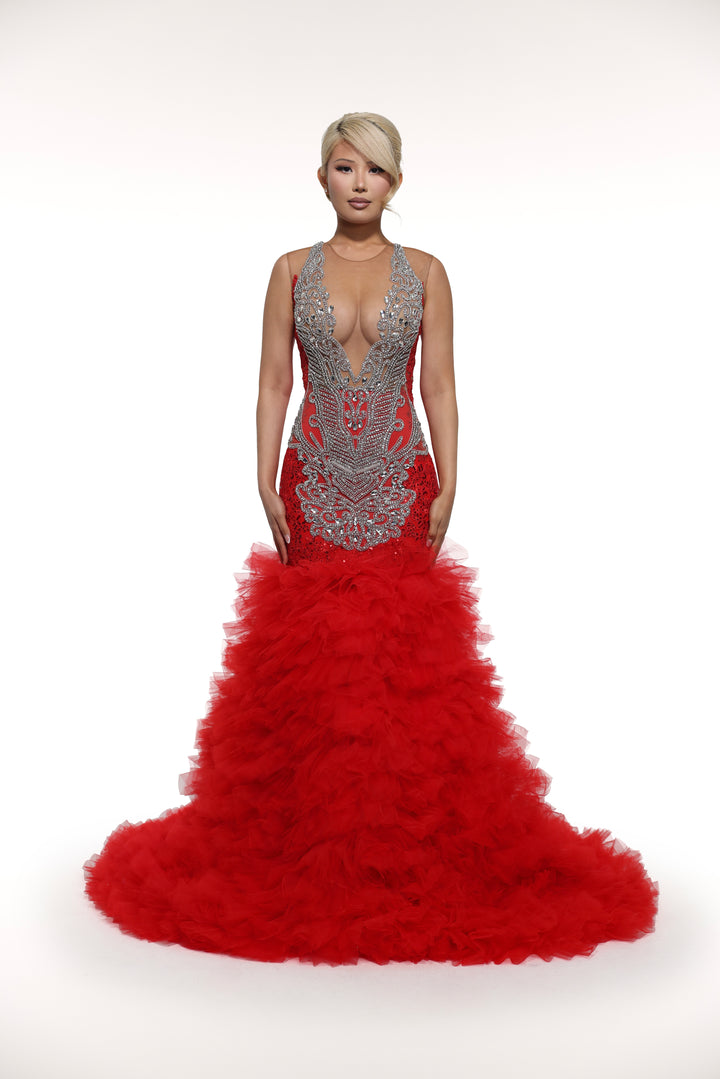 Red evening gown with intricate detailing on a white background