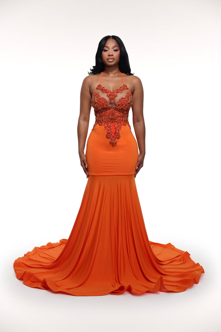 Orange evening gown with intricate top design on a white background