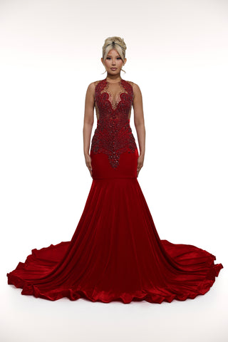 Red evening gown with intricate detailing on a white background