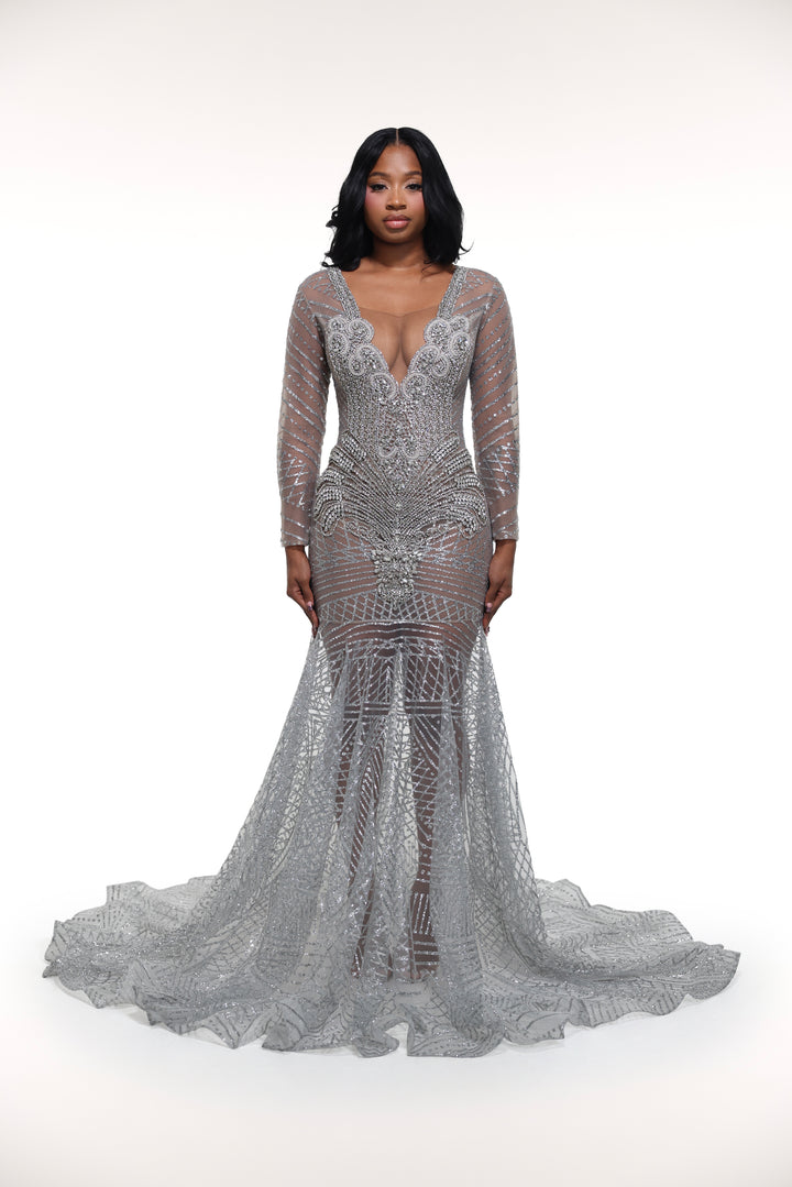 Woman wearing a silver sequin gown on a white background